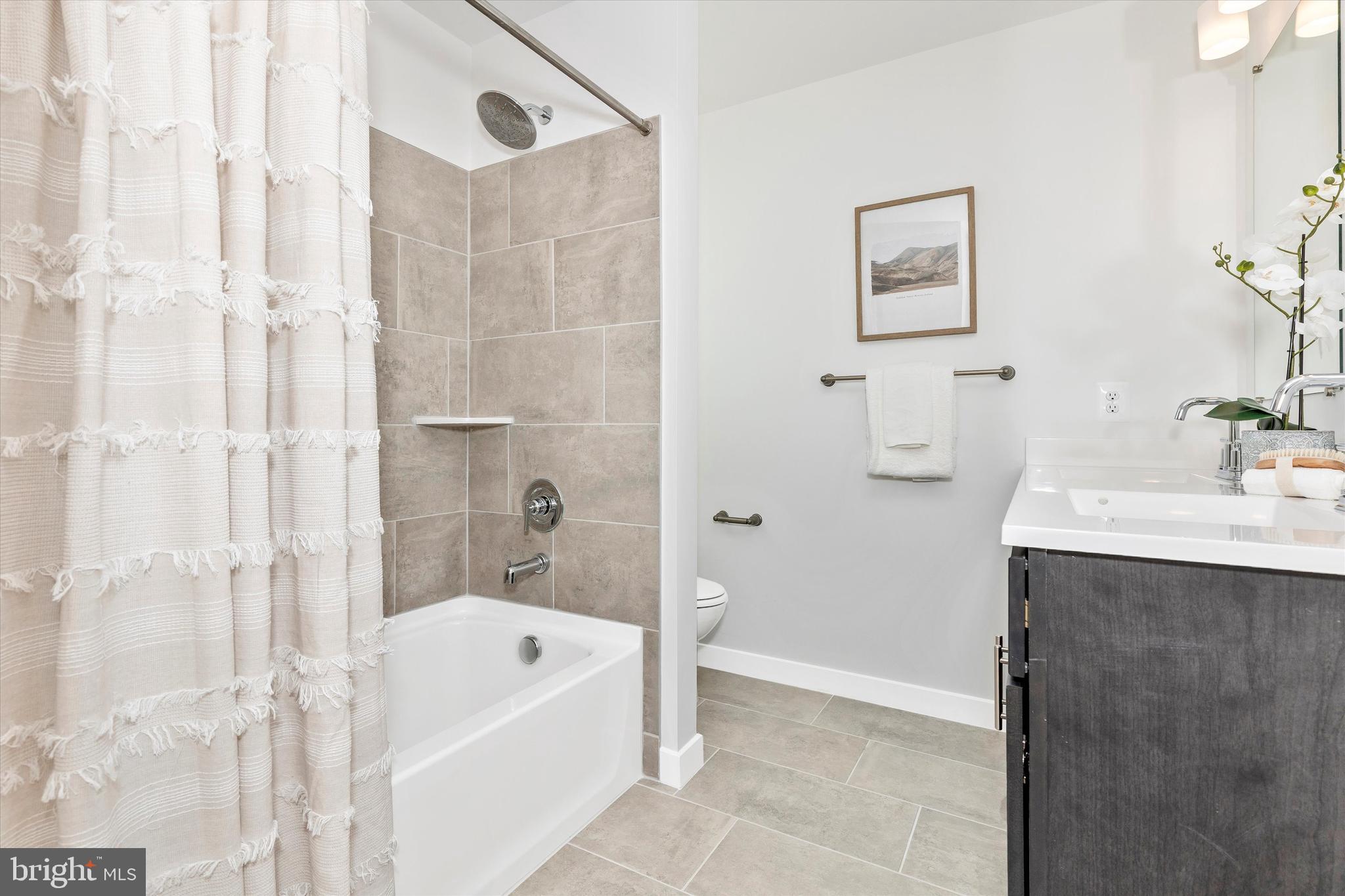 714 Iron Frg Road Frederick, MD 21702 - Photo 30 of 36 a bathroom with a tub a sink and a mirror
