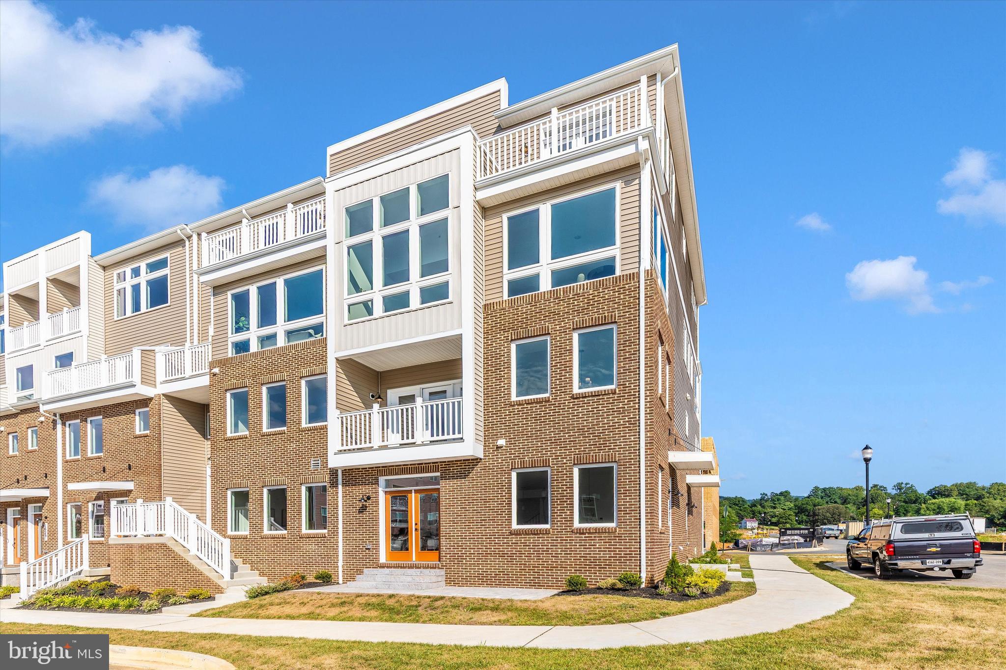 714 Iron Frg Road Frederick, MD 21702 - Photo 33 of 36 a front view of a building with lot of cars and trees