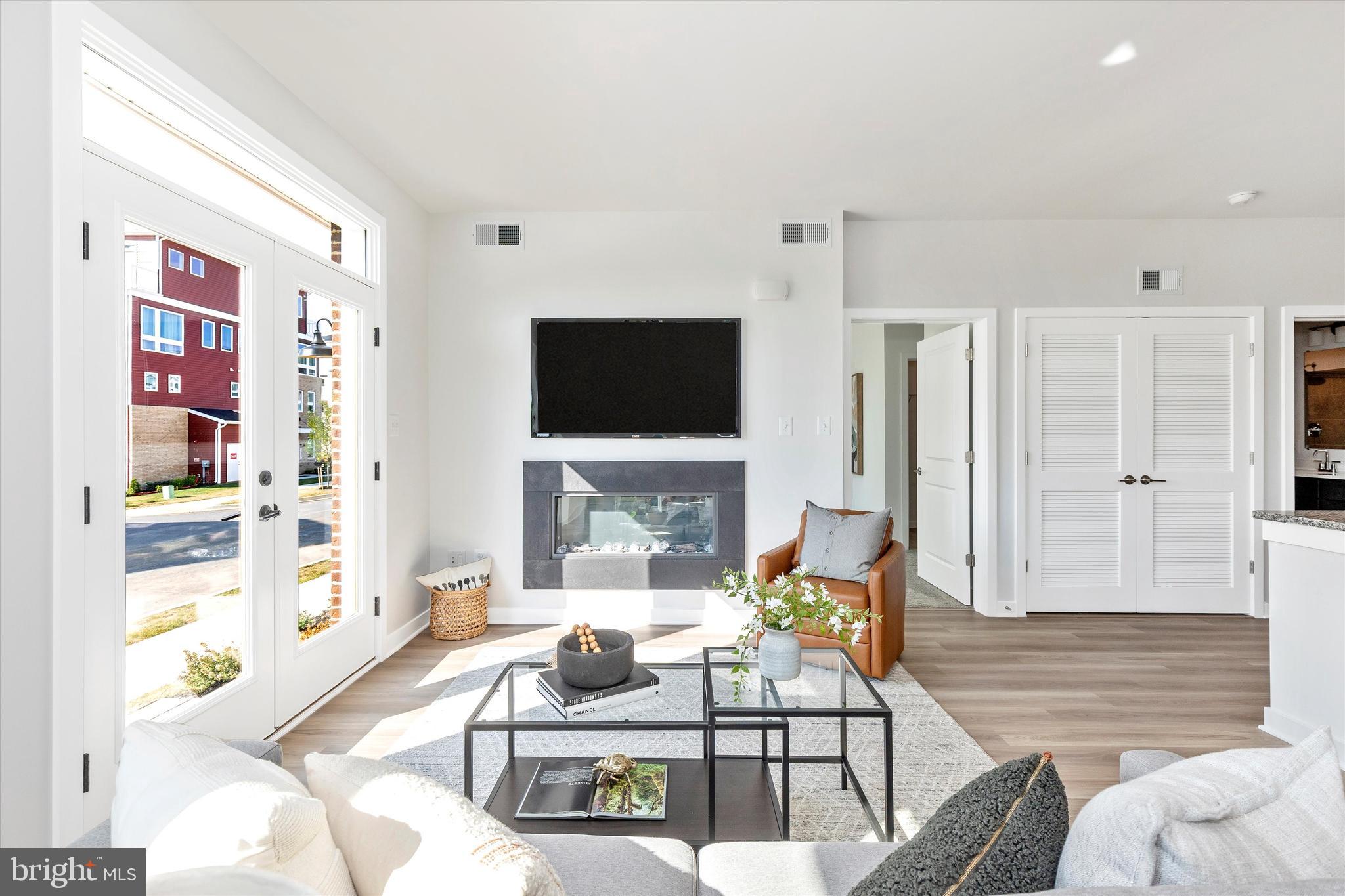 714 Iron Frg Road Frederick, MD 21702 - Photo 8 of 36 a living room with furniture a flat screen tv and a fireplace