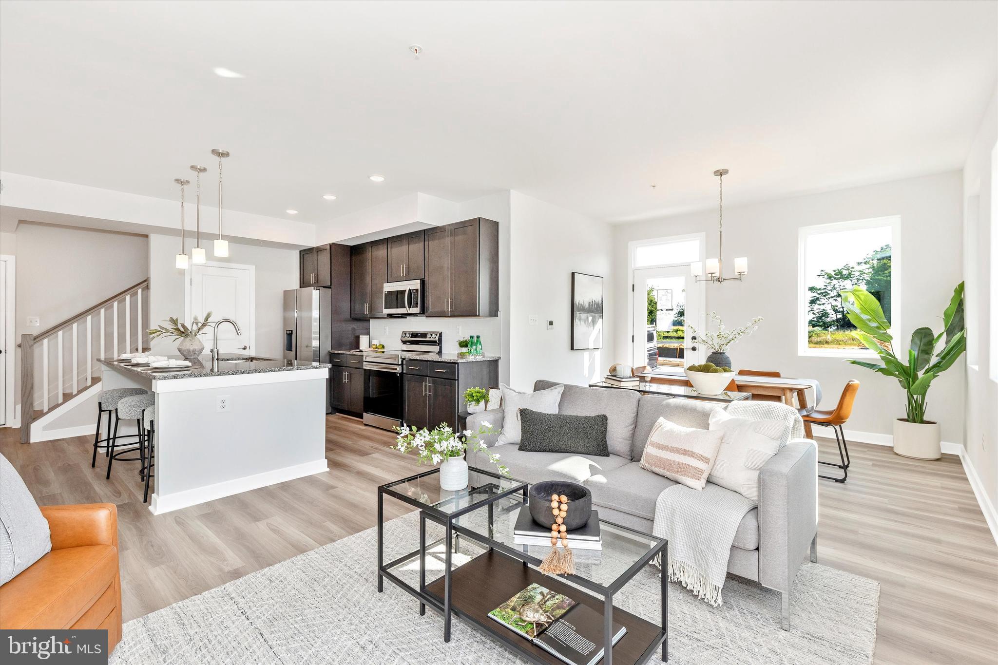 714 Iron Frg Road Frederick, MD 21702 - Photo 10 of 36 a living room with furniture a dining table wooden floor kitchen view and a chandelier