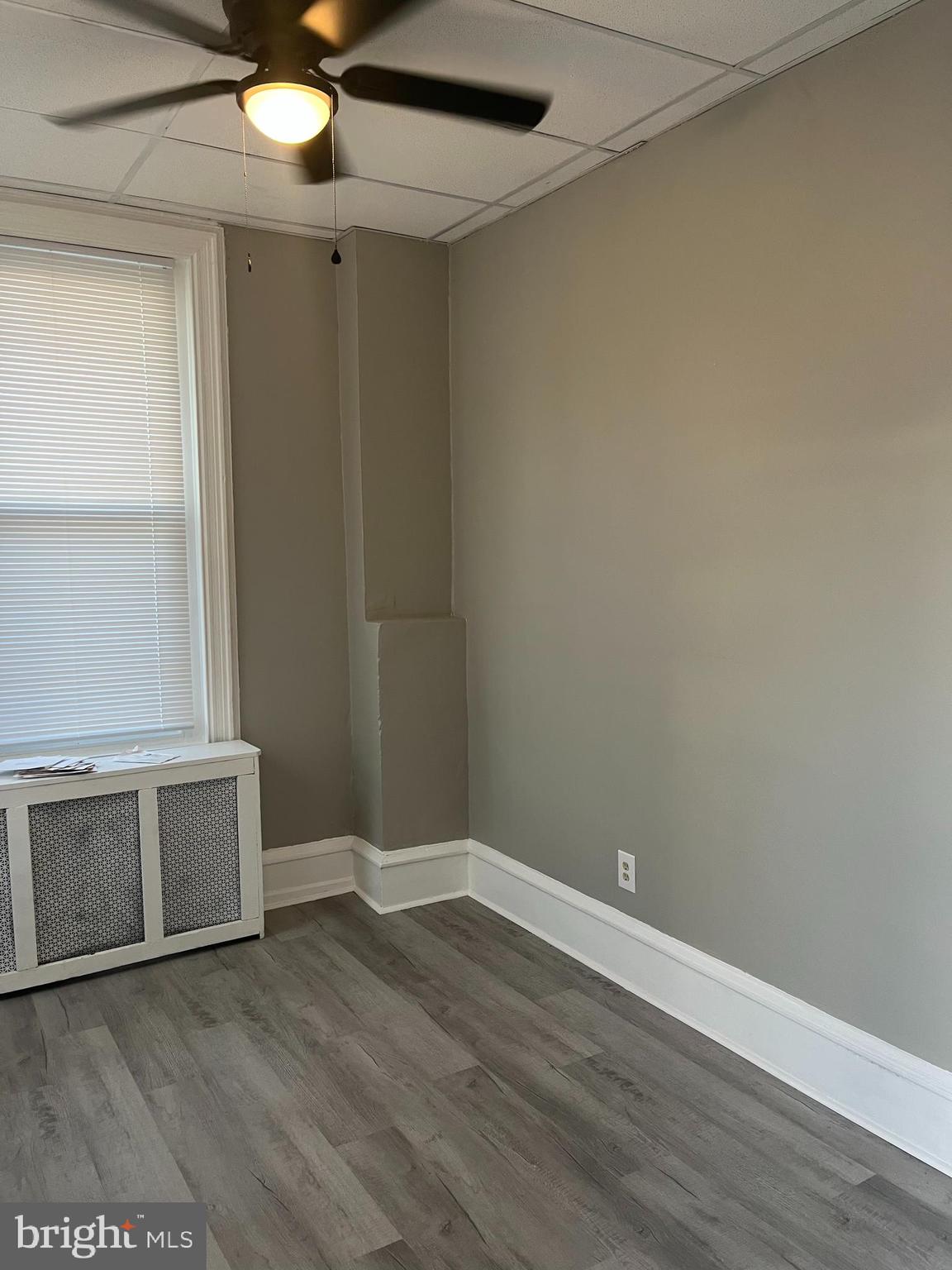 2666 Bridge Street Philadelphia, PA 19137 - Photo 18 of 25 an empty room with wooden floor and fan