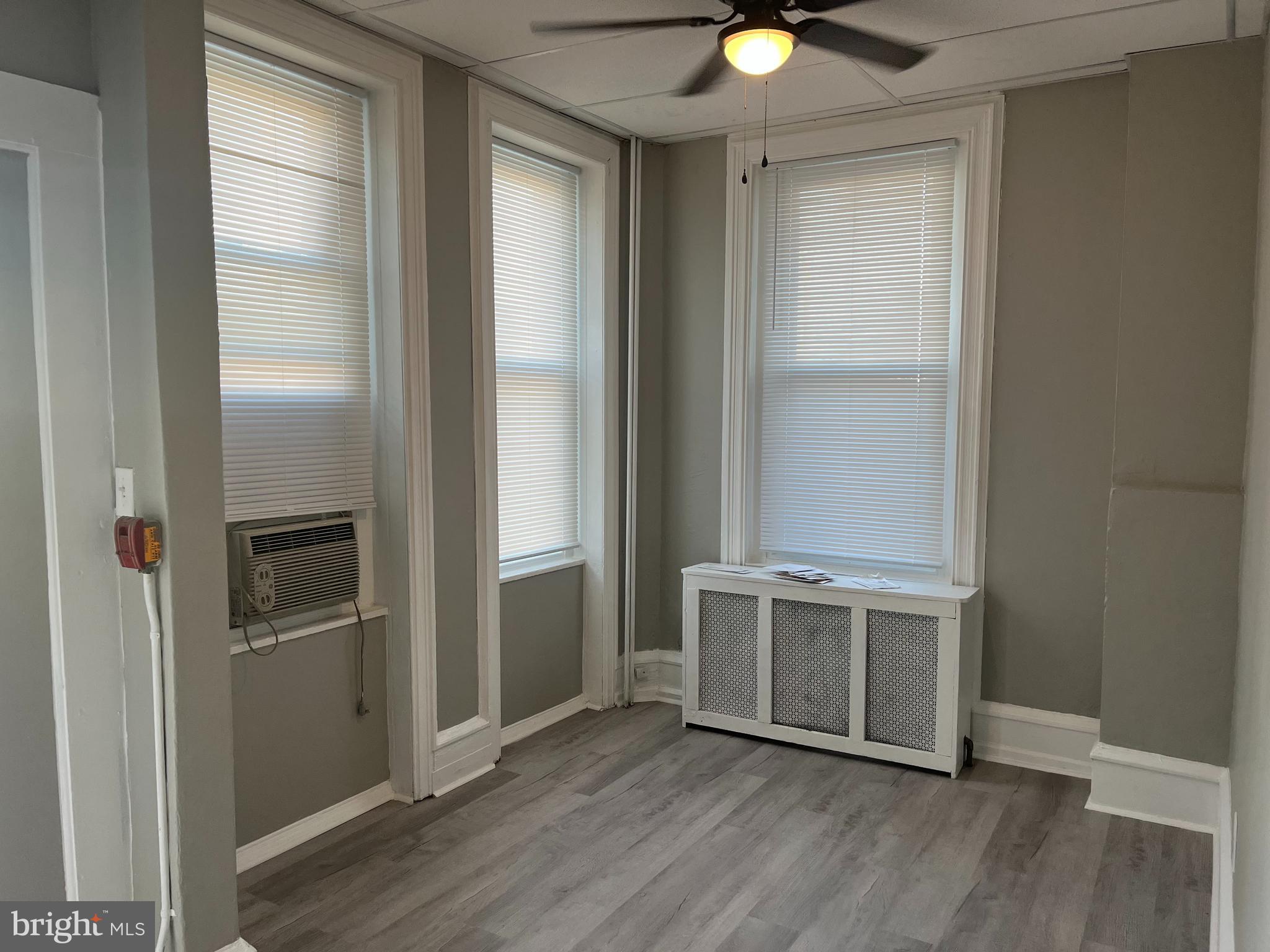2666 Bridge Street Philadelphia, PA 19137 - Photo 5 of 25 an empty room with wooden floor cabinet and windows