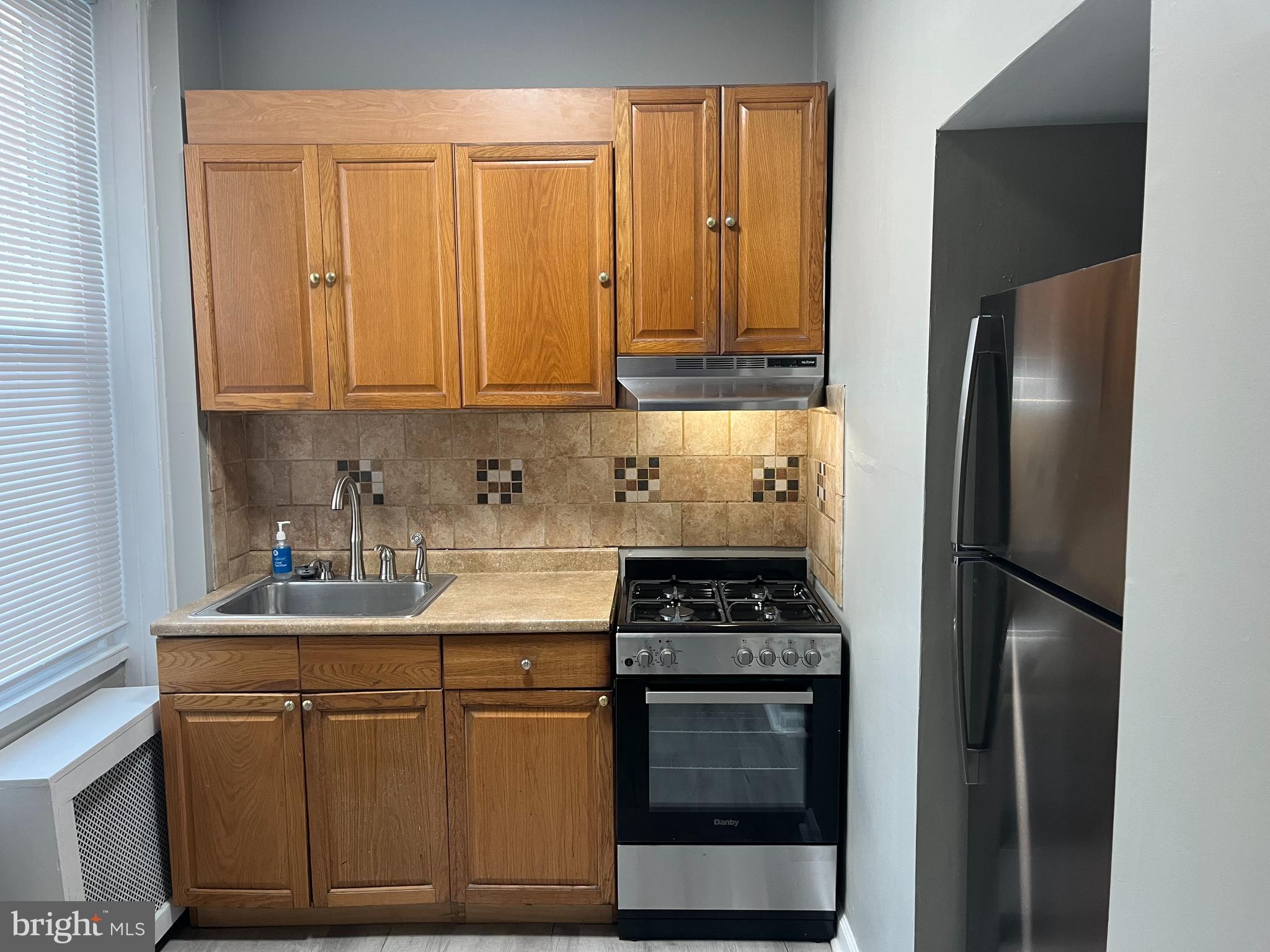 2666 Bridge Street Philadelphia, PA 19137 - Photo 10 of 25 a kitchen with stainless steel appliances granite countertop a stove a refrigerator and a sink