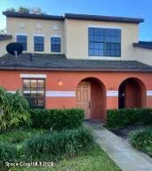 a front view of a house with plants and entryway