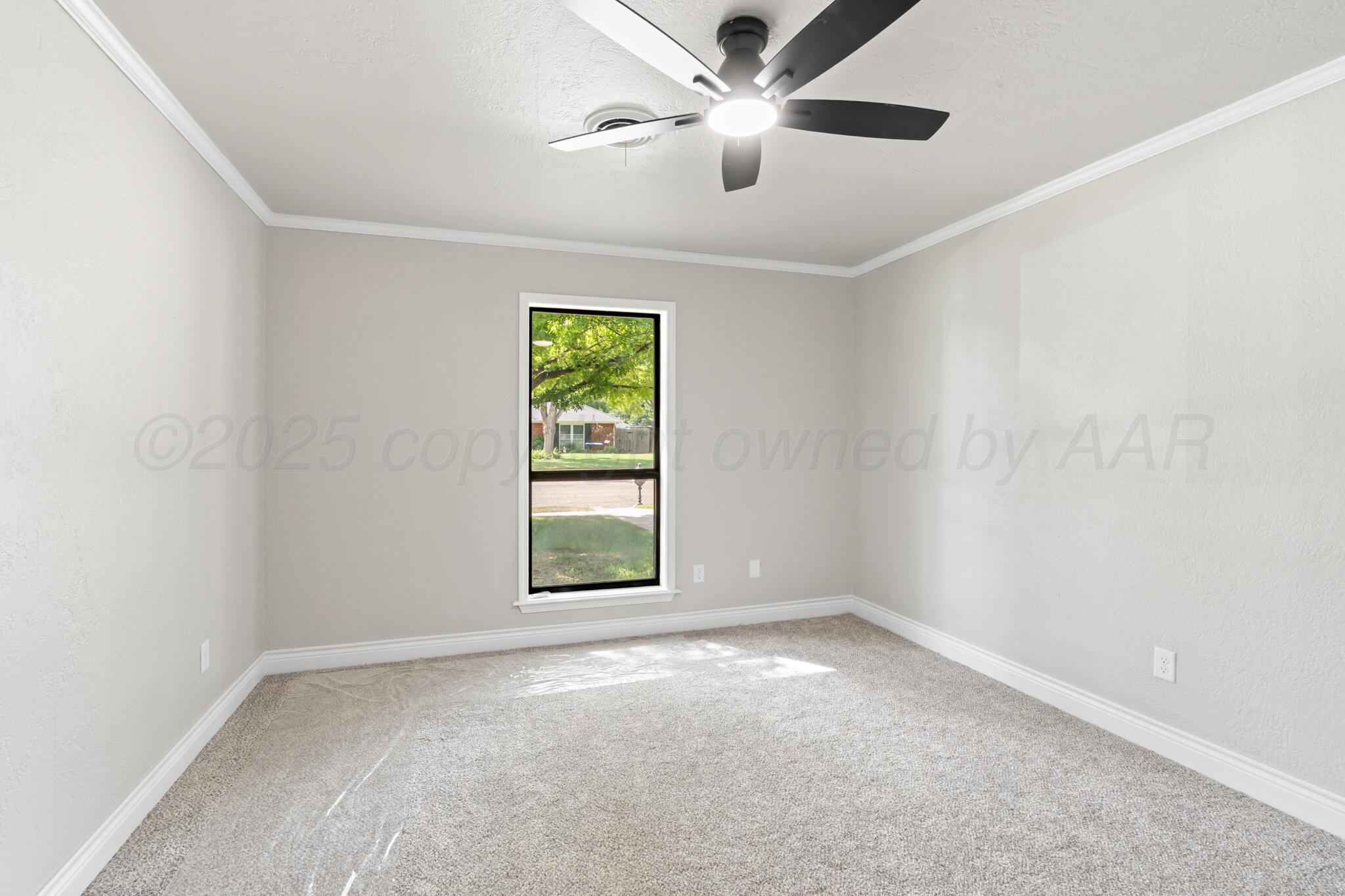 3513 Timber Drive Amarillo, TX 79121 - Photo 11 of 23 an empty room with a window and a fan