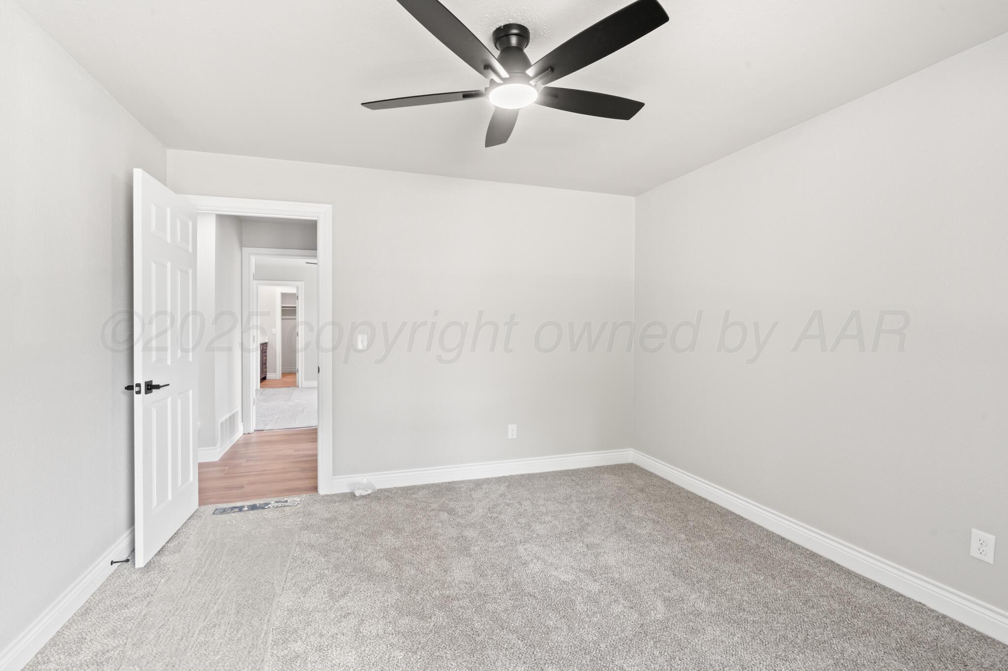 3513 Timber Drive Amarillo, TX 79121 - Photo 12 of 23 an empty room with a ceiling fan and a window