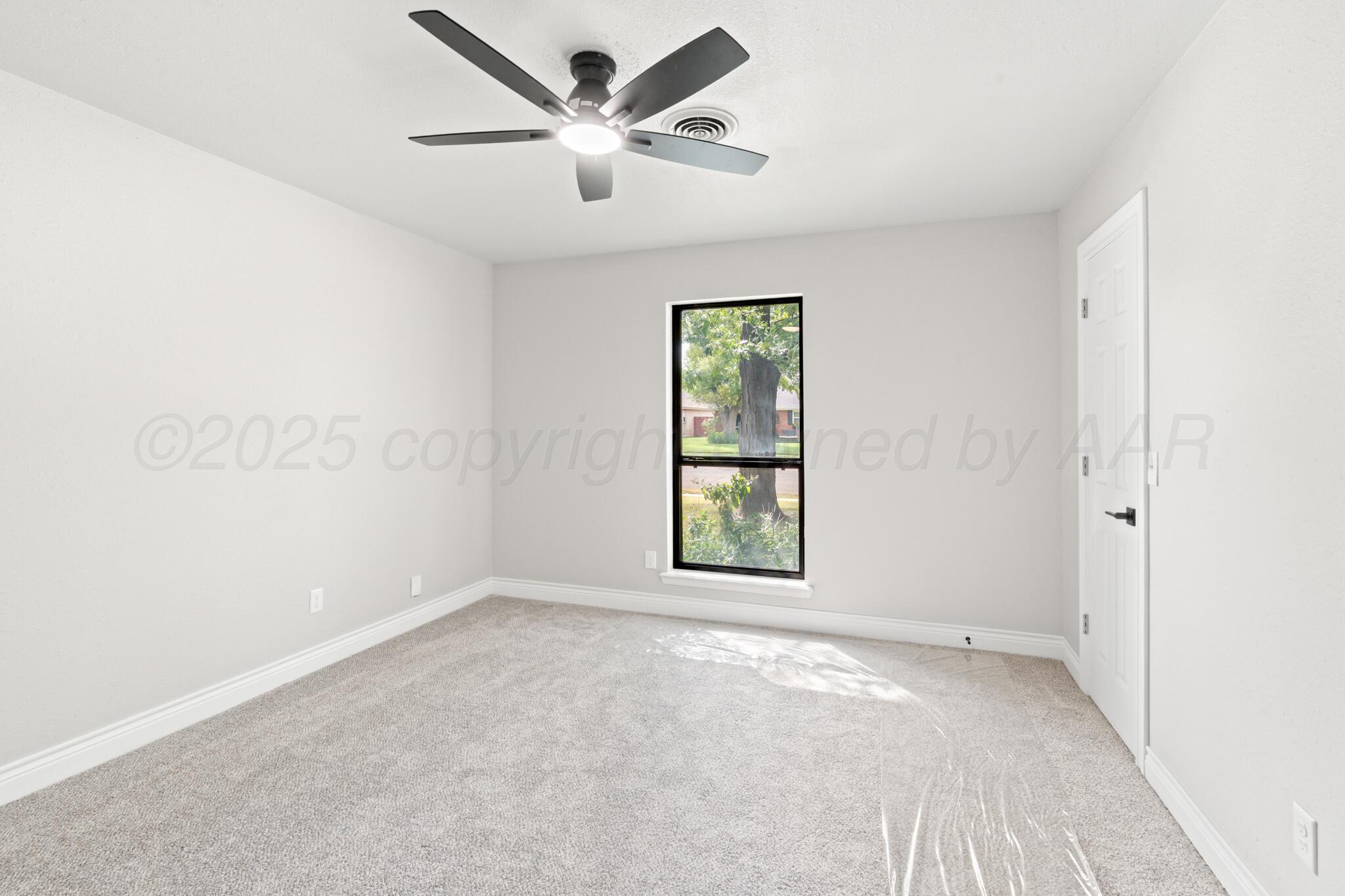 3513 Timber Drive Amarillo, TX 79121 - Photo 13 of 23 an empty room with windows and fan