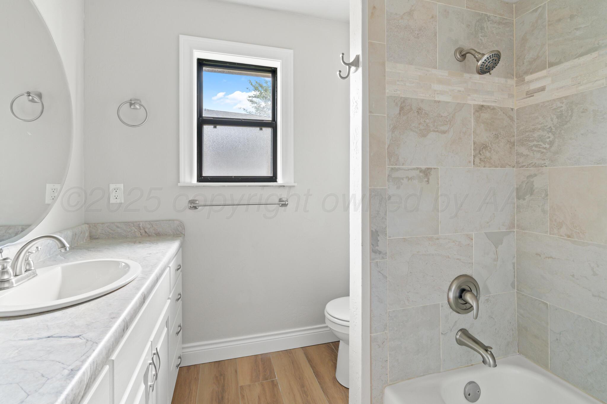 3513 Timber Drive Amarillo, TX 79121 - Photo 14 of 23 a bathroom with a sink a toilet and shower