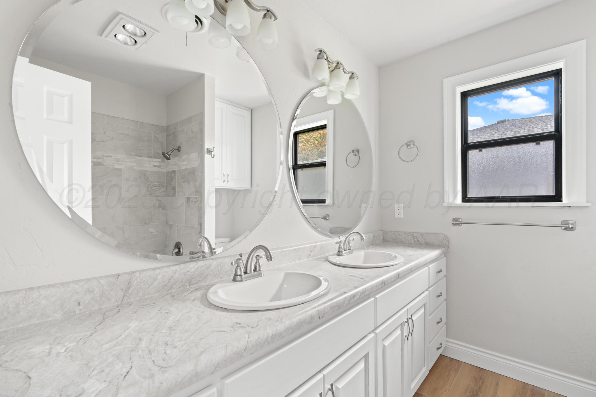 3513 Timber Drive Amarillo, TX 79121 - Photo 15 of 23 a bathroom with a sink and a mirror