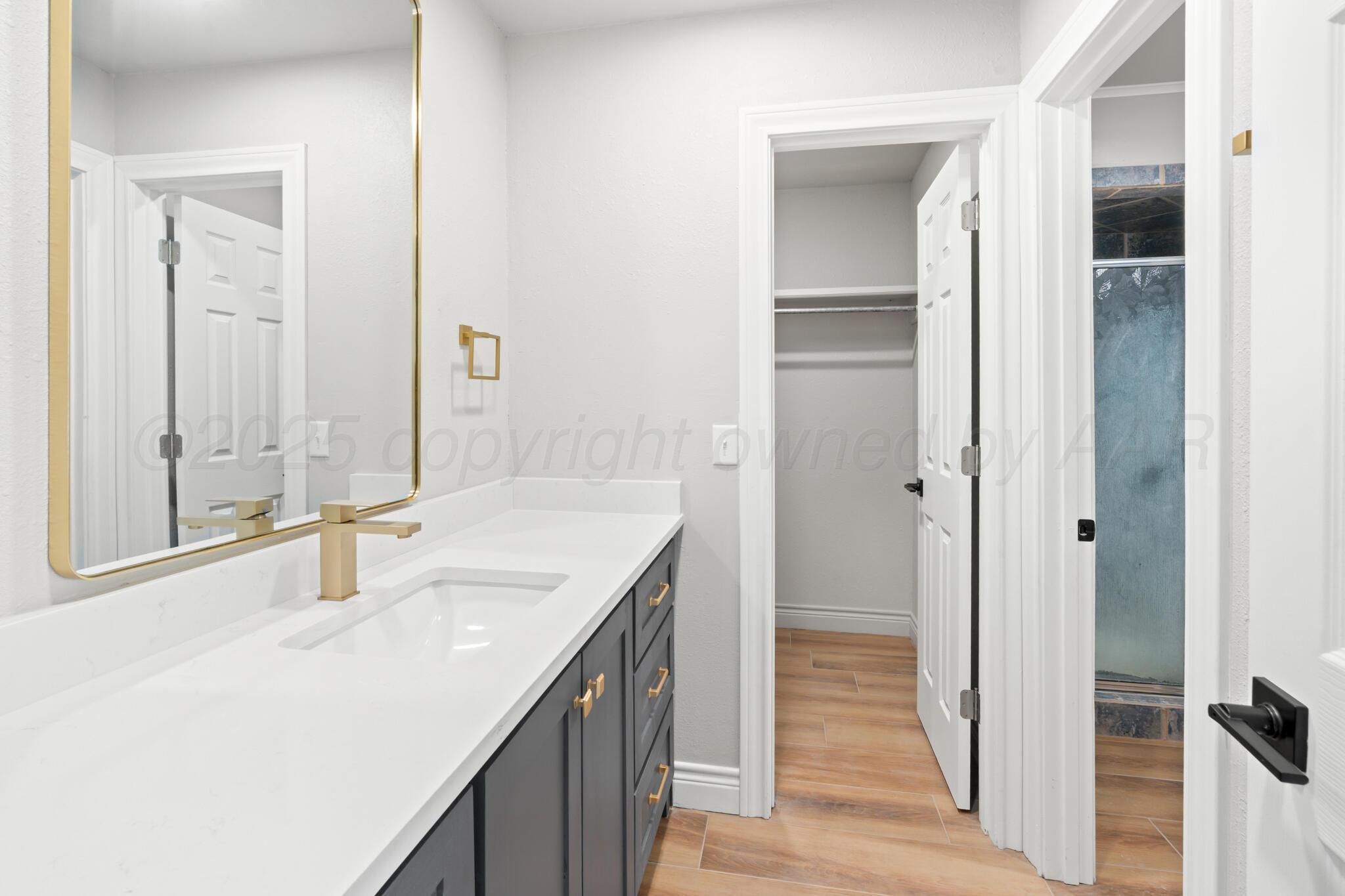 3513 Timber Drive Amarillo, TX 79121 - Photo 18 of 23 a bathroom with a sink and a mirror