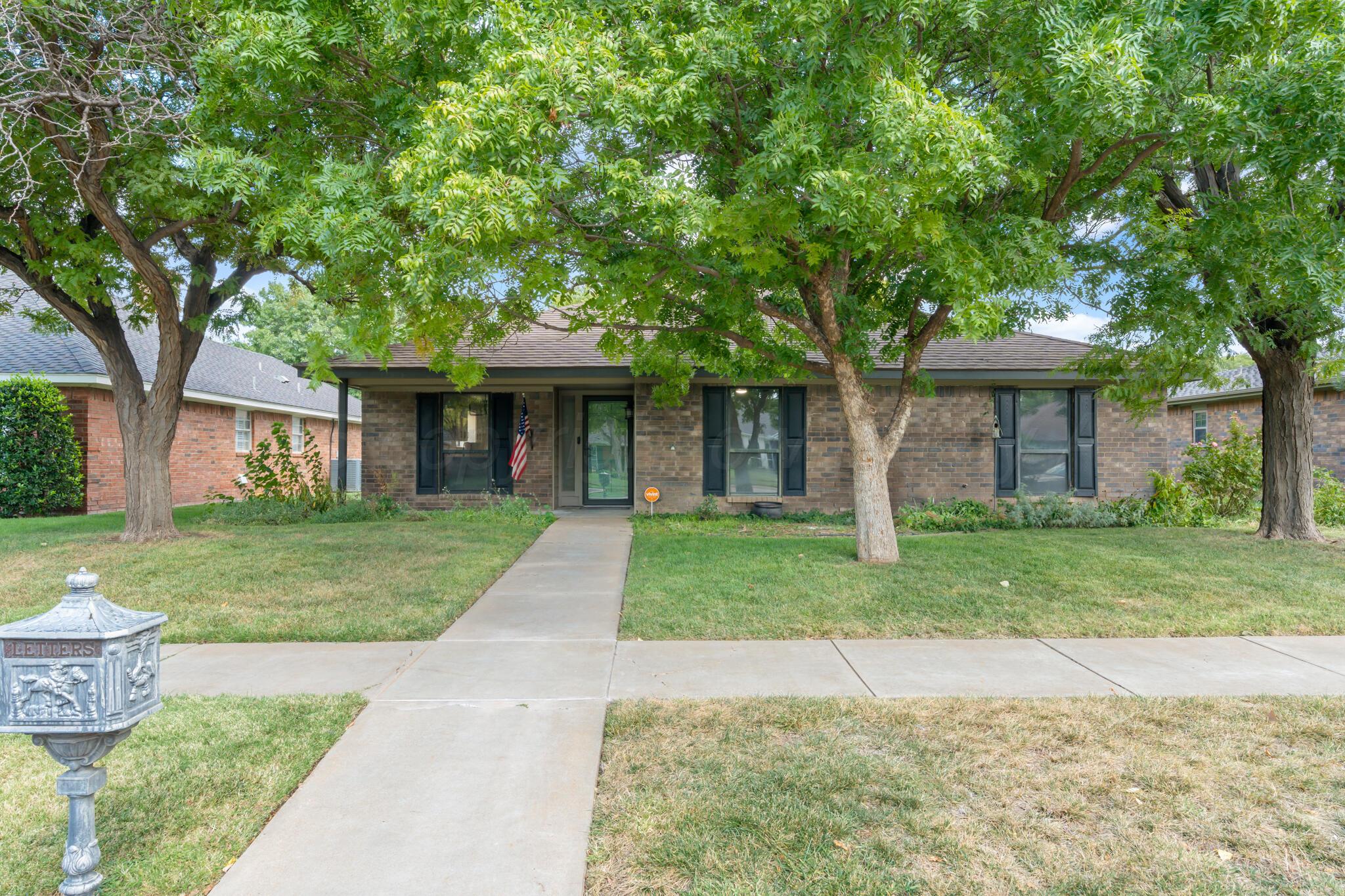 3513 Timber Drive Amarillo, TX 79121 - Photo 2 of 23 front view of a brick house with a yard