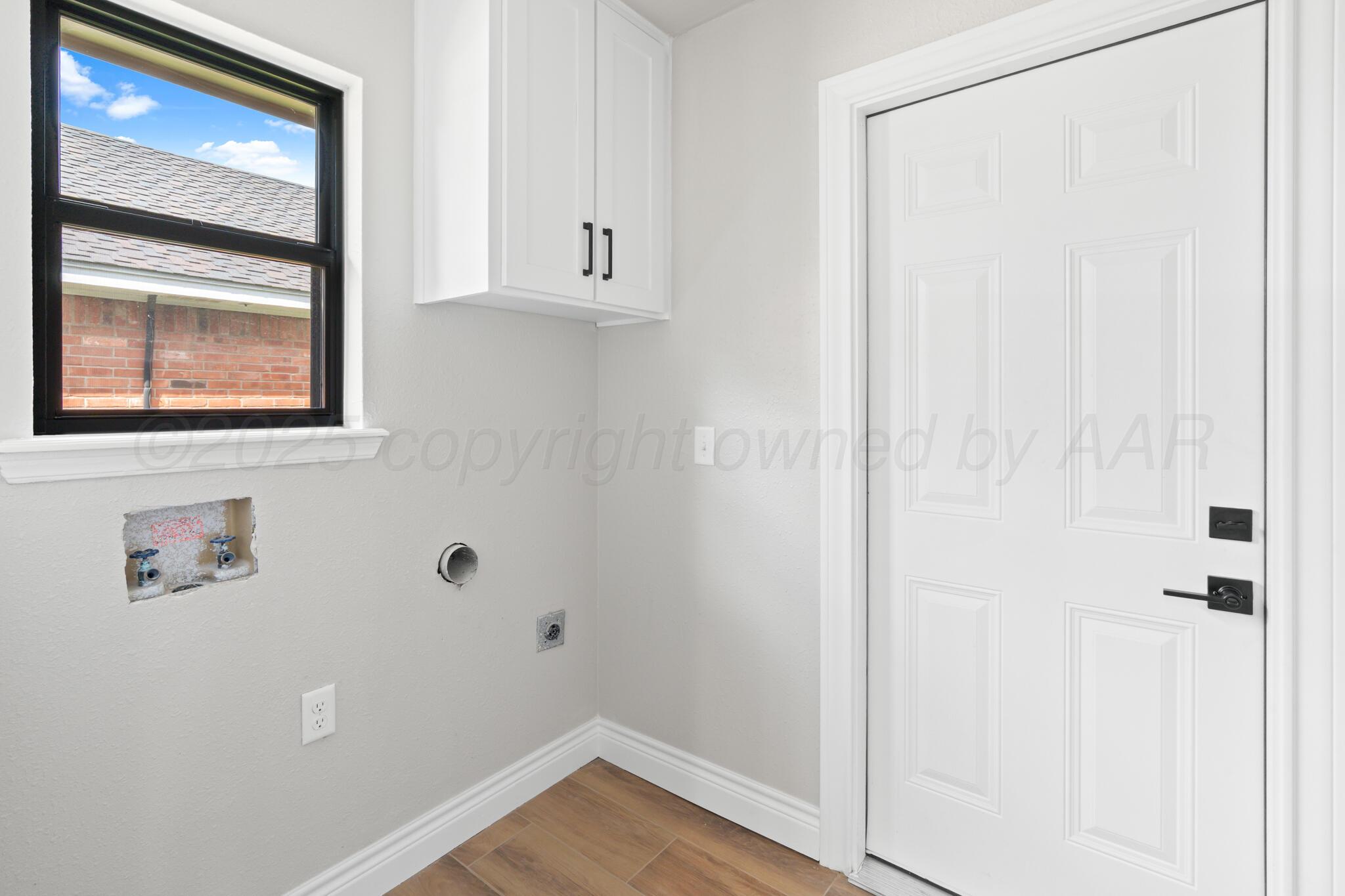 3513 Timber Drive Amarillo, TX 79121 - Photo 21 of 23 a view of an empty room with wooden floor and a window