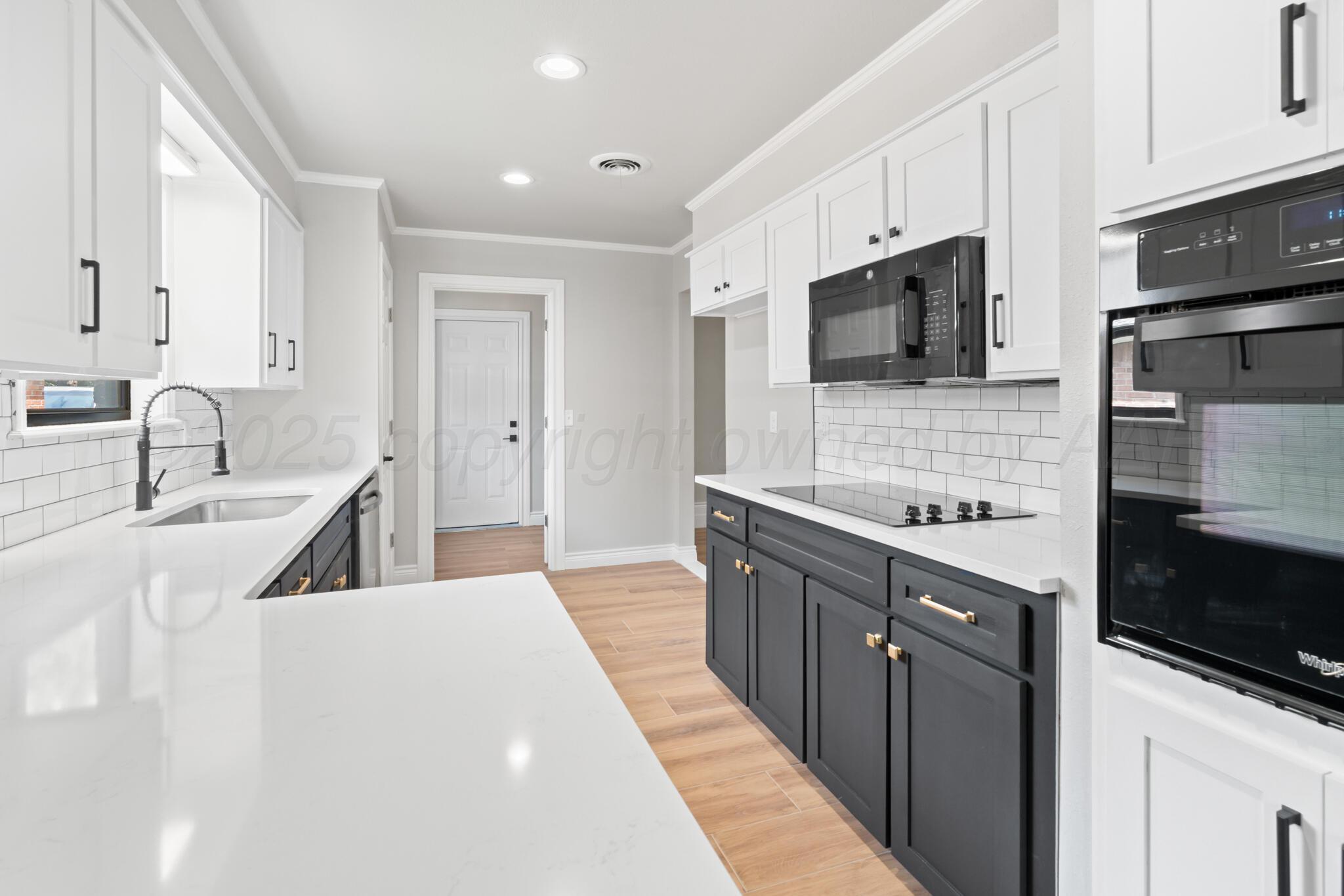 3513 Timber Drive Amarillo, TX 79121 - Photo 6 of 23 a kitchen with stainless steel appliances a sink dishwasher stove refrigerator and microwave