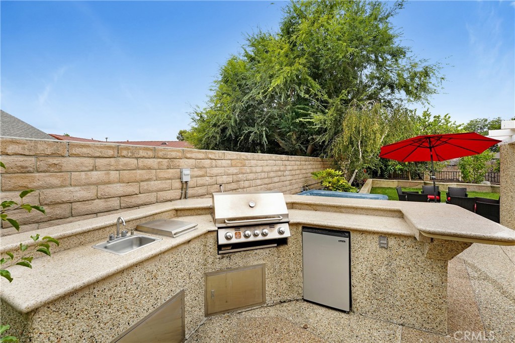 3265 Sheri Drive Simi Valley, CA 93063 - Photo 21 of 25 a view of a patio with a table and chairs under an umbrella