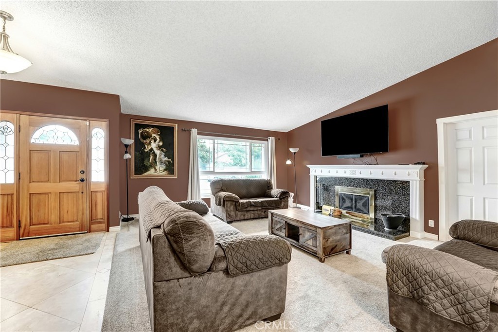 3265 Sheri Drive Simi Valley, CA 93063 - Photo 3 of 25 a living room with furniture a fireplace and a flat screen tv