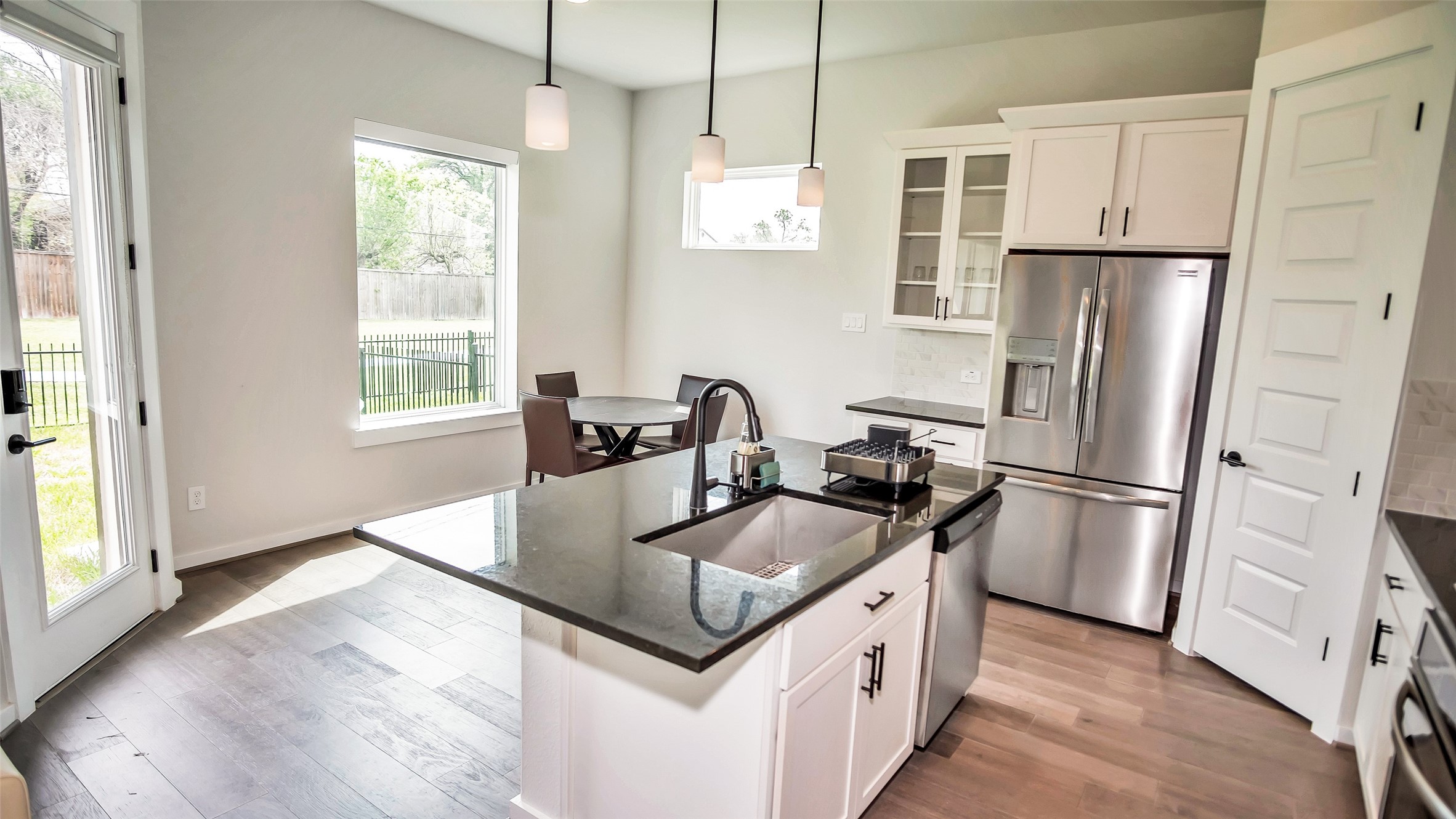 1919 Pueblo Nuevo Path Houston, TX 77077 - Photo 43 of 50 a kitchen with stainless steel appliances granite countertop a refrigerator a sink a stove and island