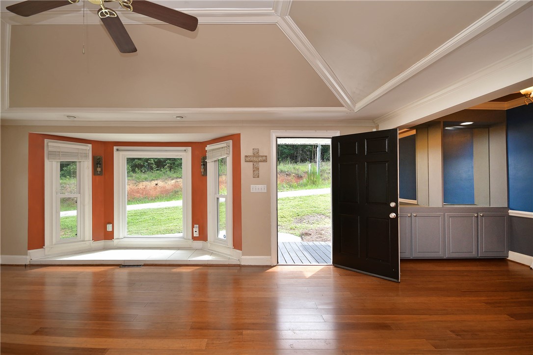 197 Deer Creek Road Easley, SC 29640 - Photo 6 of 50 Rich hardwood floors welcome you into this living area, offering a charming bay window and a direct walkout to the outdoors.