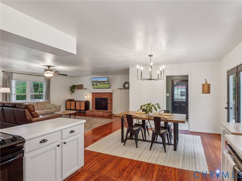 2568 Crewsville Road Bumpass, VA 23024 - Photo 11 of 30 a kitchen with granite countertop kitchen island stainless steel appliances a dining table and chairs