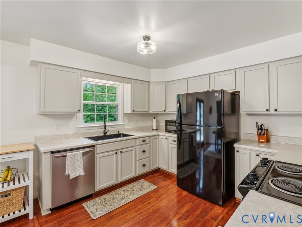 2568 Crewsville Road Bumpass, VA 23024 - Photo 13 of 30 a kitchen with stainless steel appliances a stove refrigerator sink and cabinets
