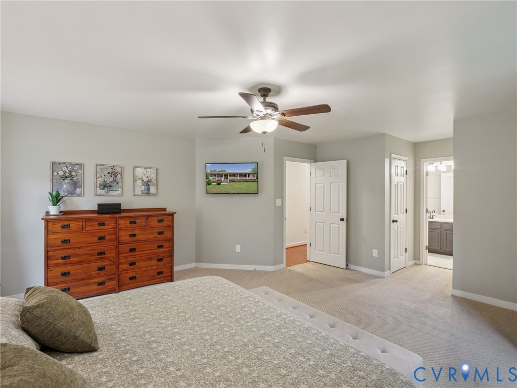 2568 Crewsville Road Bumpass, VA 23024 - Photo 19 of 30 a bedroom with a dresser and a chandelier