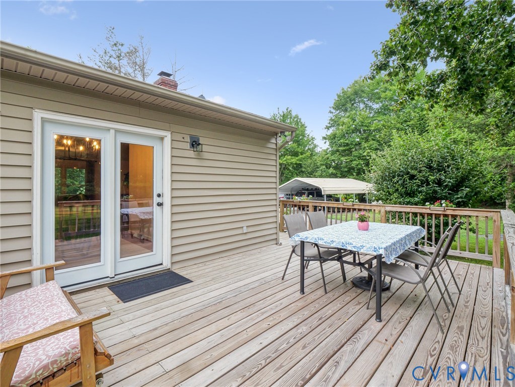 2568 Crewsville Road Bumpass, VA 23024 - Photo 29 of 30 a roof deck with table and chairs and wooden floor