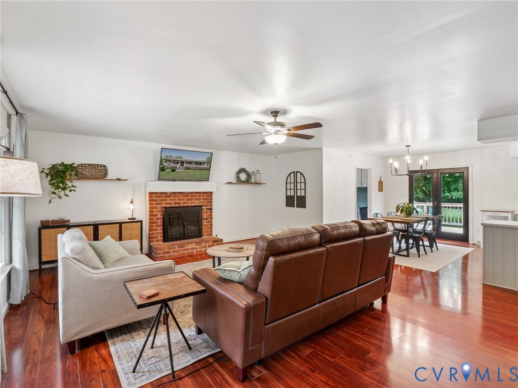 2568 Crewsville Road Bumpass, VA 23024 - Photo 5 of 30 a living room with furniture a fireplace and wooden floor