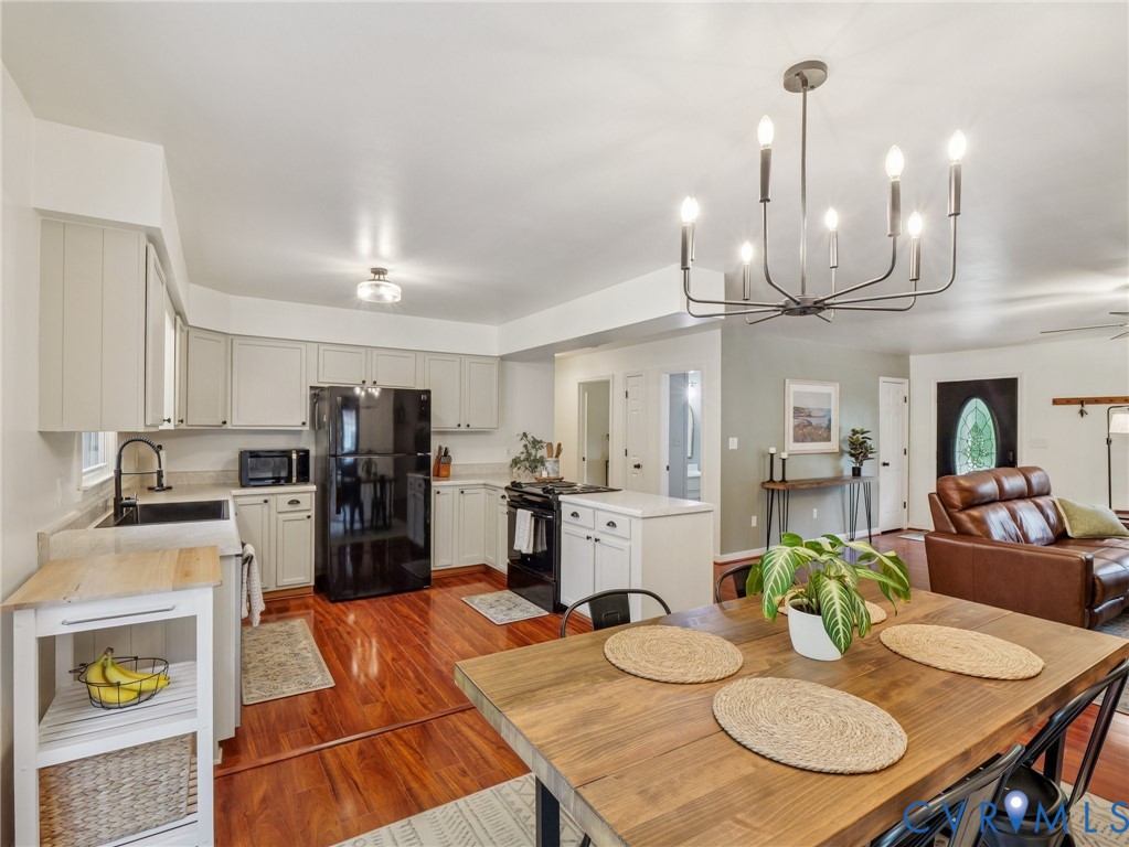2568 Crewsville Road Bumpass, VA 23024 - Photo 9 of 30 a kitchen with stainless steel appliances kitchen island granite countertop a table chairs and a wooden floor