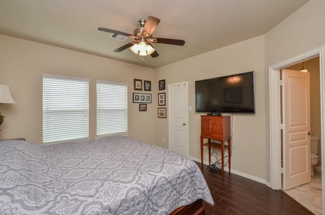 a bedroom with a bed and a flat screen tv
