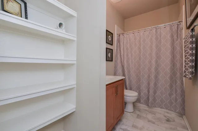 a bathroom with a toilet and shower