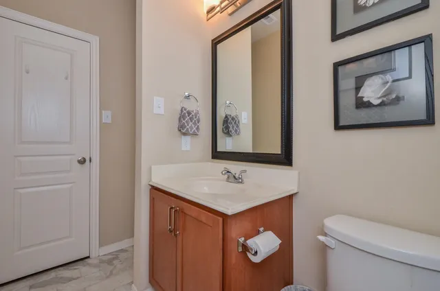 a bathroom with a toilet sink and mirror