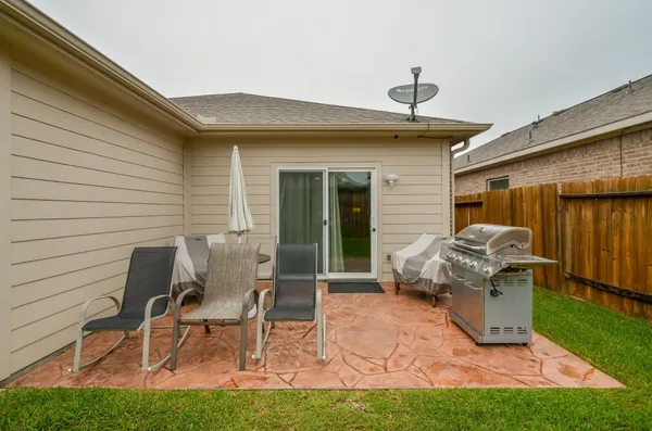 a view of a patio with chair and tables