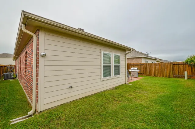 a view of a backyard with plants and a backyard