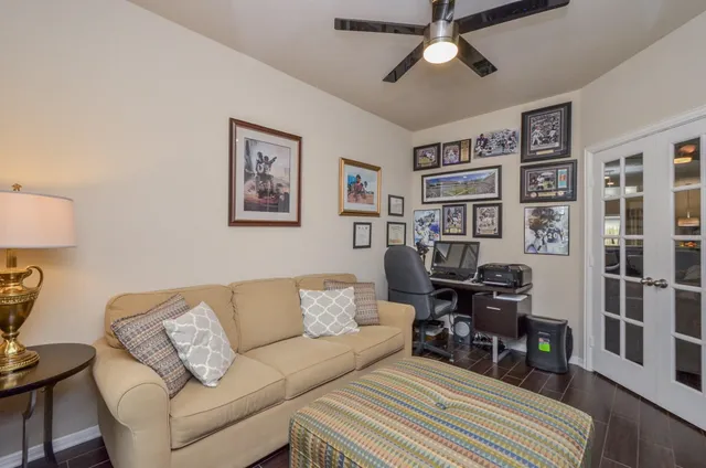 a living room with furniture a bookshelf and a piano