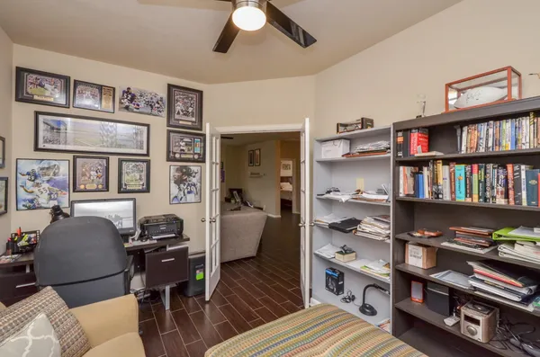 a living room with furniture and a book shelf
