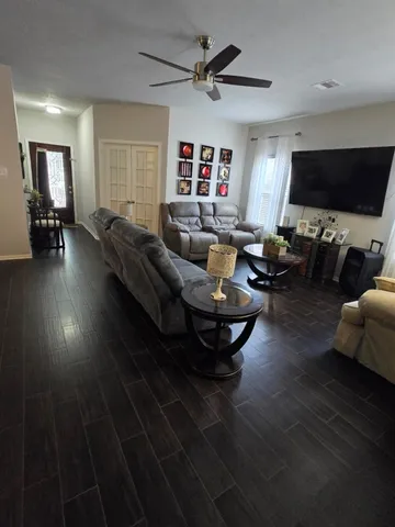a living room with furniture and a flat screen tv