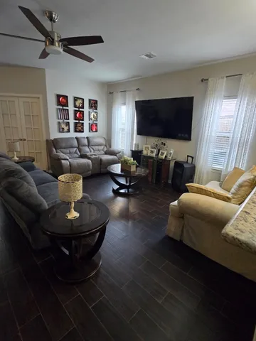 a living room with furniture and a flat screen tv