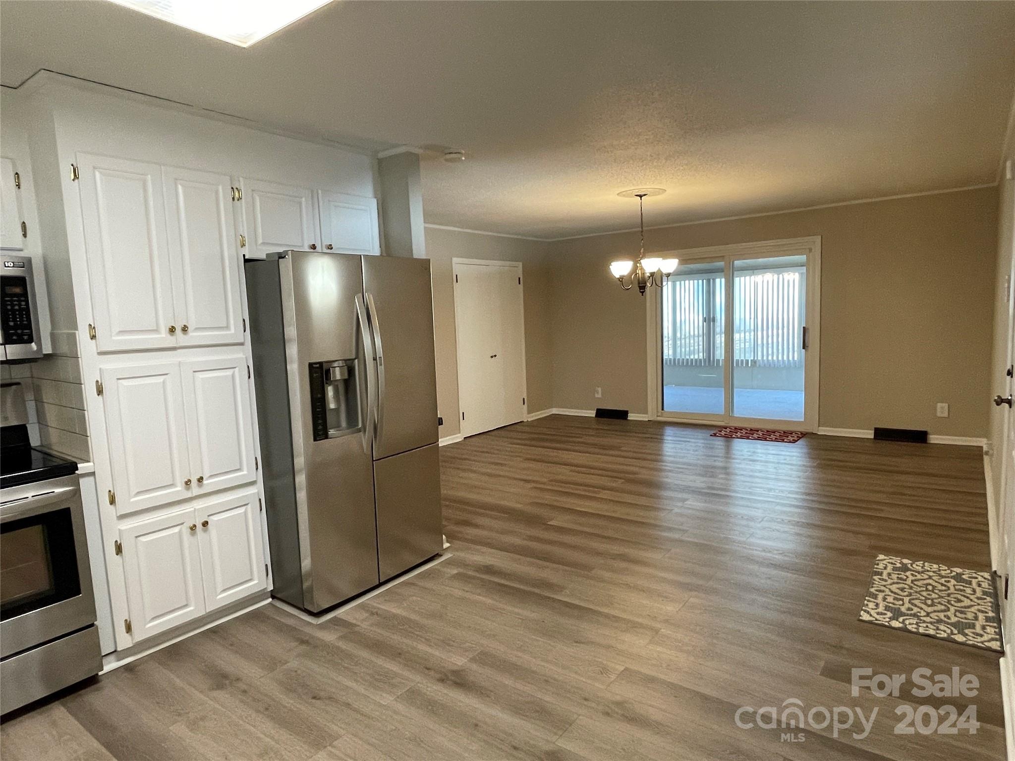 228 Shadowbrook Road Stanley, NC 28164 - Photo 15 of 44 a view of a refrigerator in kitchen and wooden floor