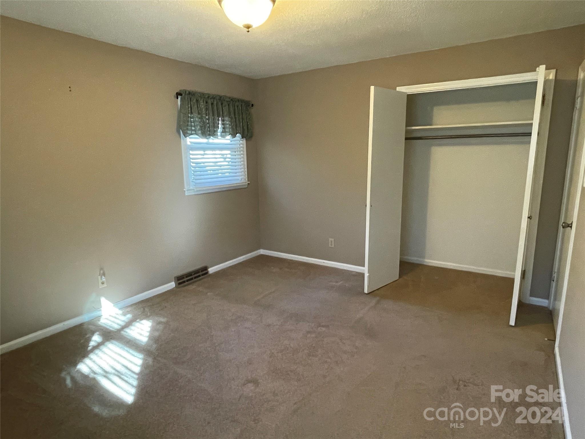 228 Shadowbrook Road Stanley, NC 28164 - Photo 29 of 44 an empty room with windows and closet