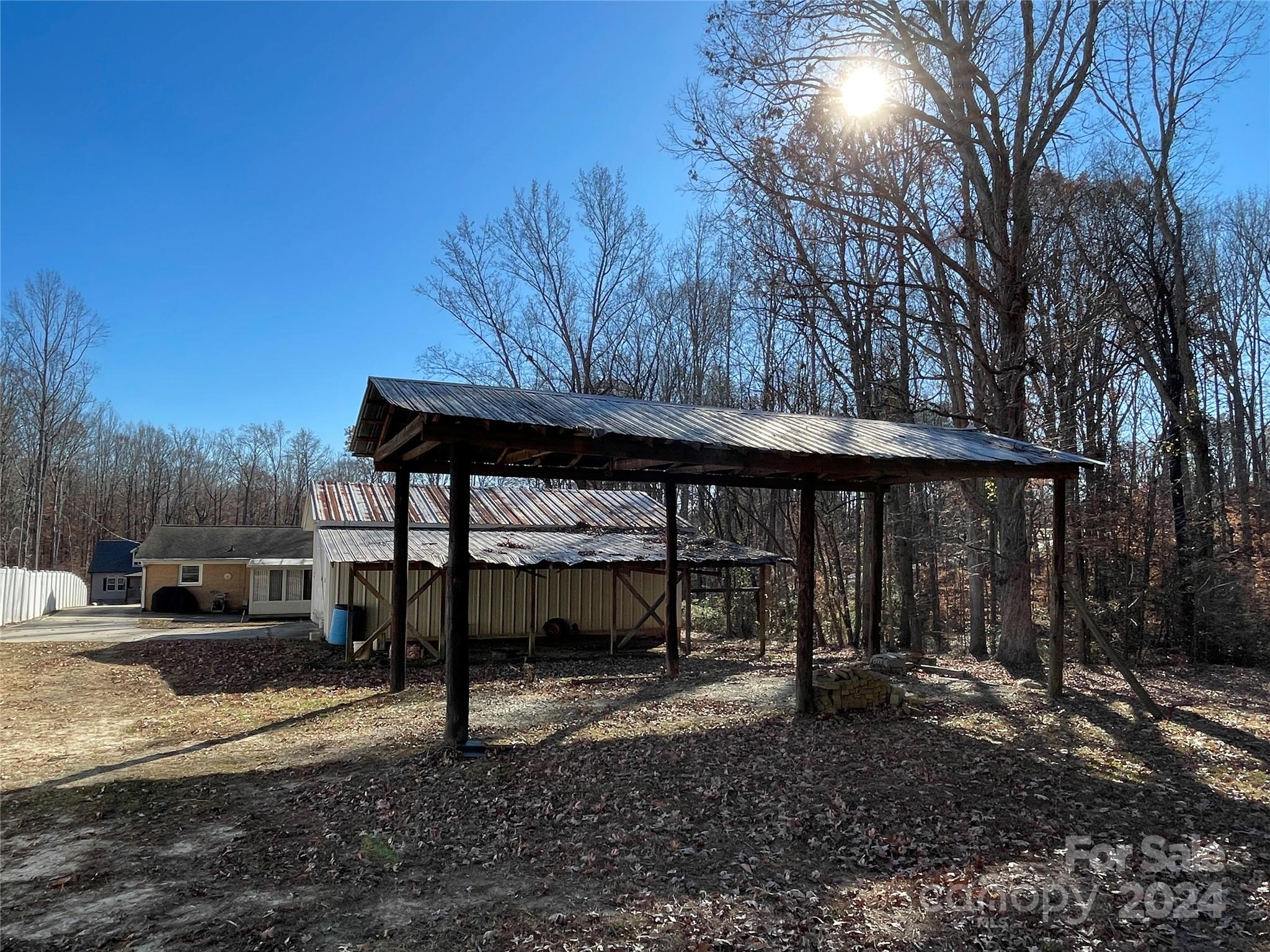 228 Shadowbrook Road Stanley, NC 28164 - Photo 38 of 44 a view of a backyard with large trees and wooden fence