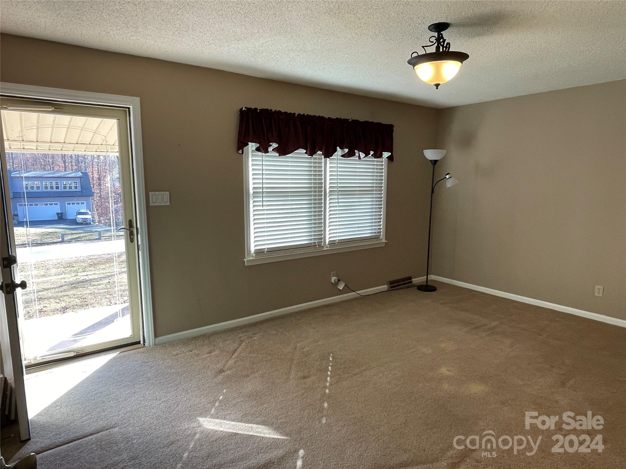 228 Shadowbrook Road Stanley, NC 28164 - Photo 9 of 44 a view of an empty room with a window