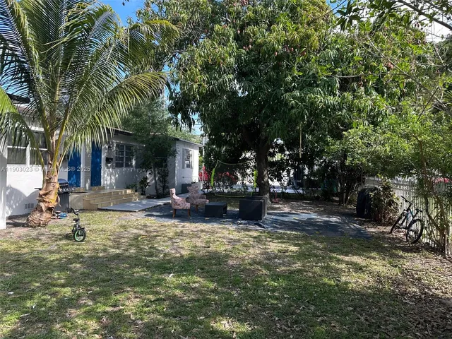 a view of a house with swimming pool and sitting area