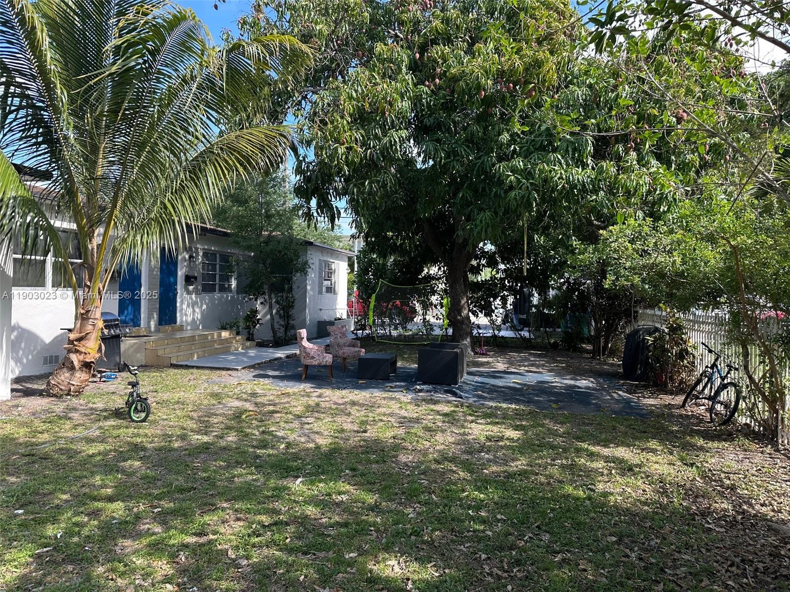 1250 Northwest 58th Street, Unit 1 Miami, FL 33142 - Photo 3 of 10 a view of a house with swimming pool and sitting area