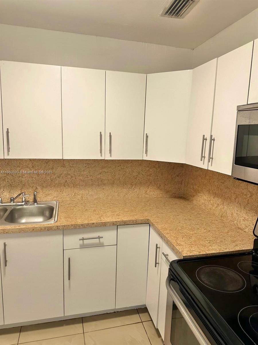 1250 Northwest 58th Street, Unit 1 Miami, FL 33142 - Photo 8 of 10 a view of washer and dryer