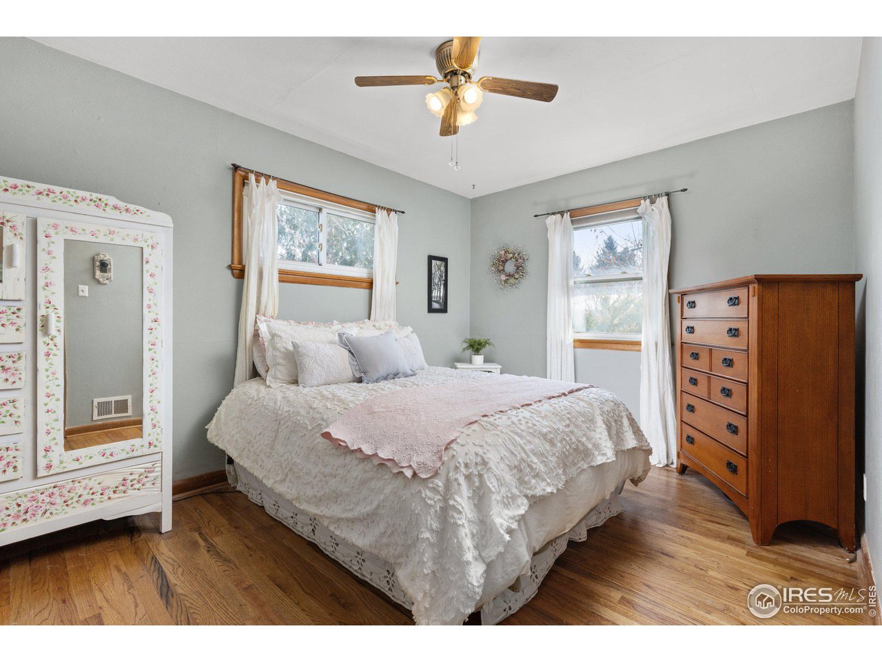 6 Sunset Circle Longmont, CO 80501 - Photo 12 of 37 a bedroom with a bed and a painting on the wall