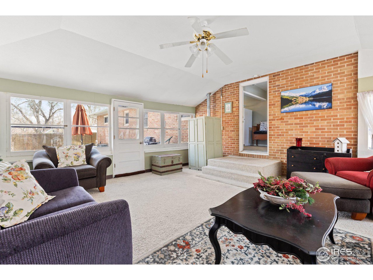 6 Sunset Circle Longmont, CO 80501 - Photo 13 of 37 a living room with furniture and a large window
