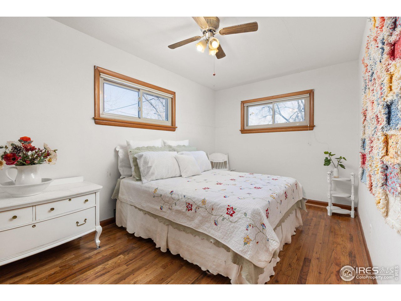6 Sunset Circle Longmont, CO 80501 - Photo 16 of 37 a bedroom with a bed and a dresser