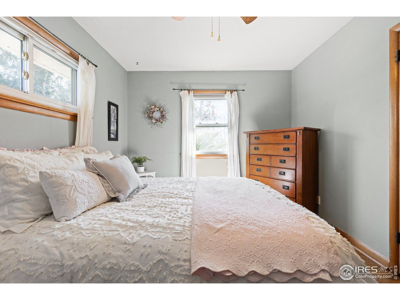6 Sunset Circle Longmont, CO 80501 - Photo 19 of 37 a bedroom with a bed and a window