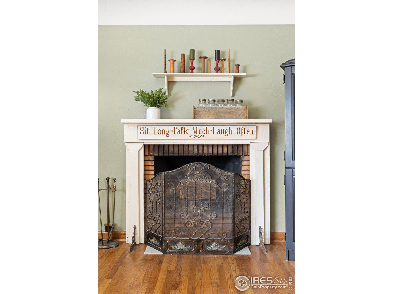 6 Sunset Circle Longmont, CO 80501 - Photo 4 of 37 a room with a fireplace and a painting on the wall