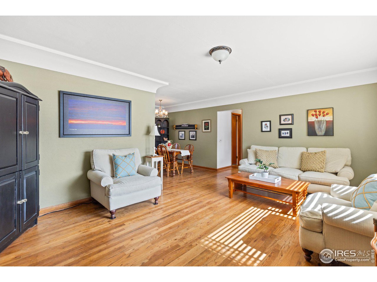 6 Sunset Circle Longmont, CO 80501 - Photo 5 of 37 a living room with furniture and a wooden floor