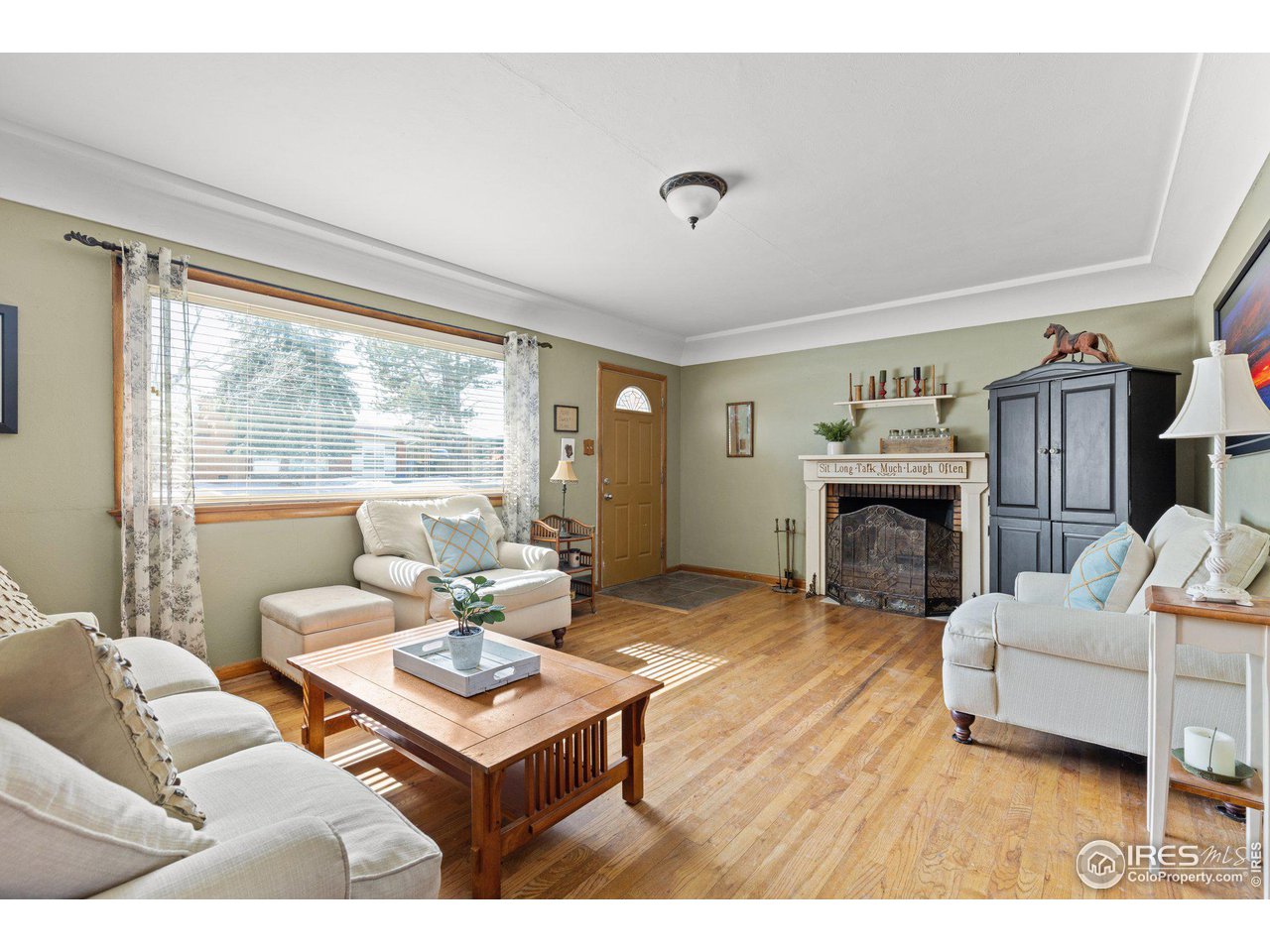6 Sunset Circle Longmont, CO 80501 - Photo 6 of 37 a living room with furniture a fireplace and a table